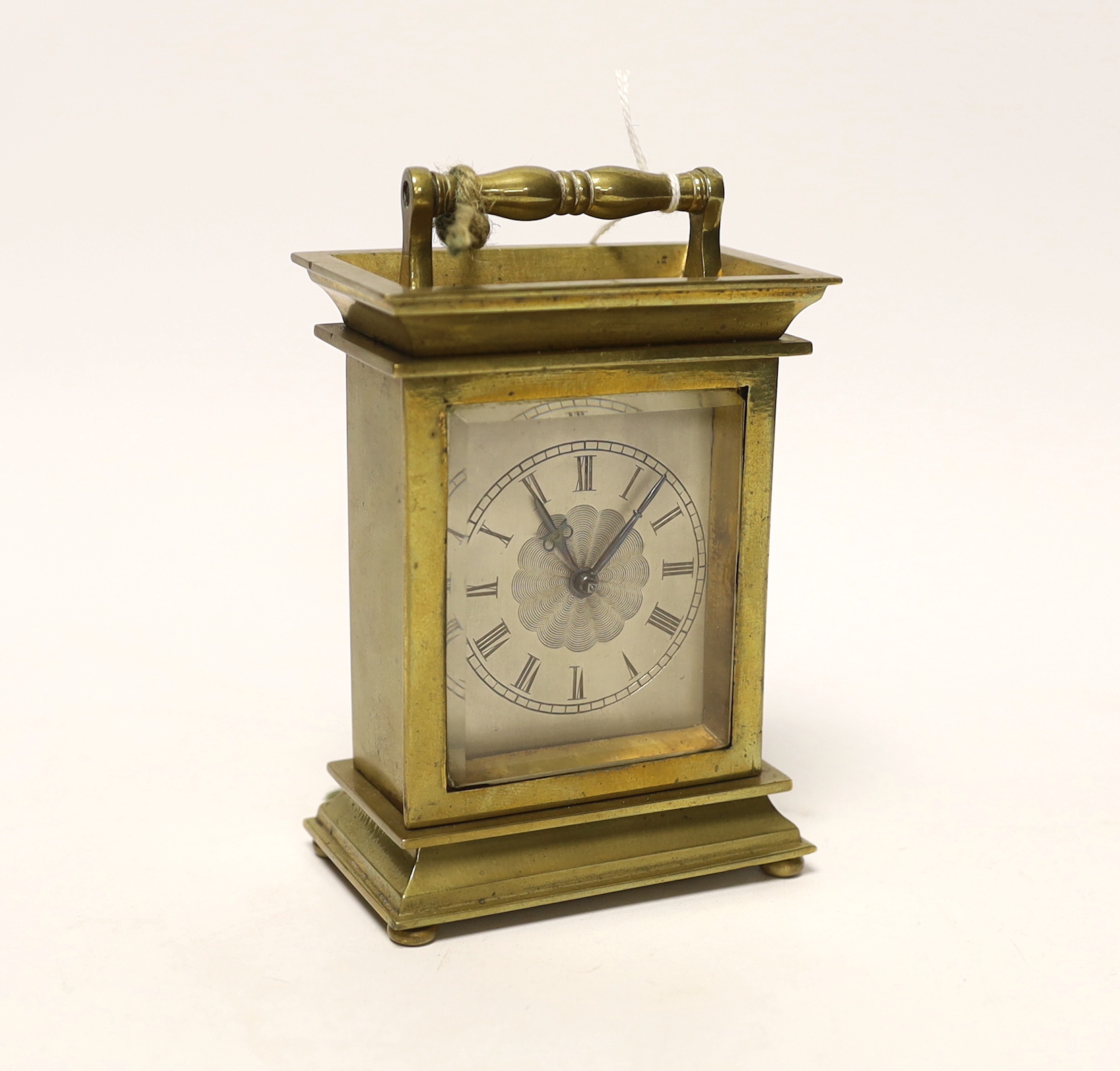 A brass carriage timepiece with machine turned face, signed to the backplate Merrick, Windsor, 11.5cm high